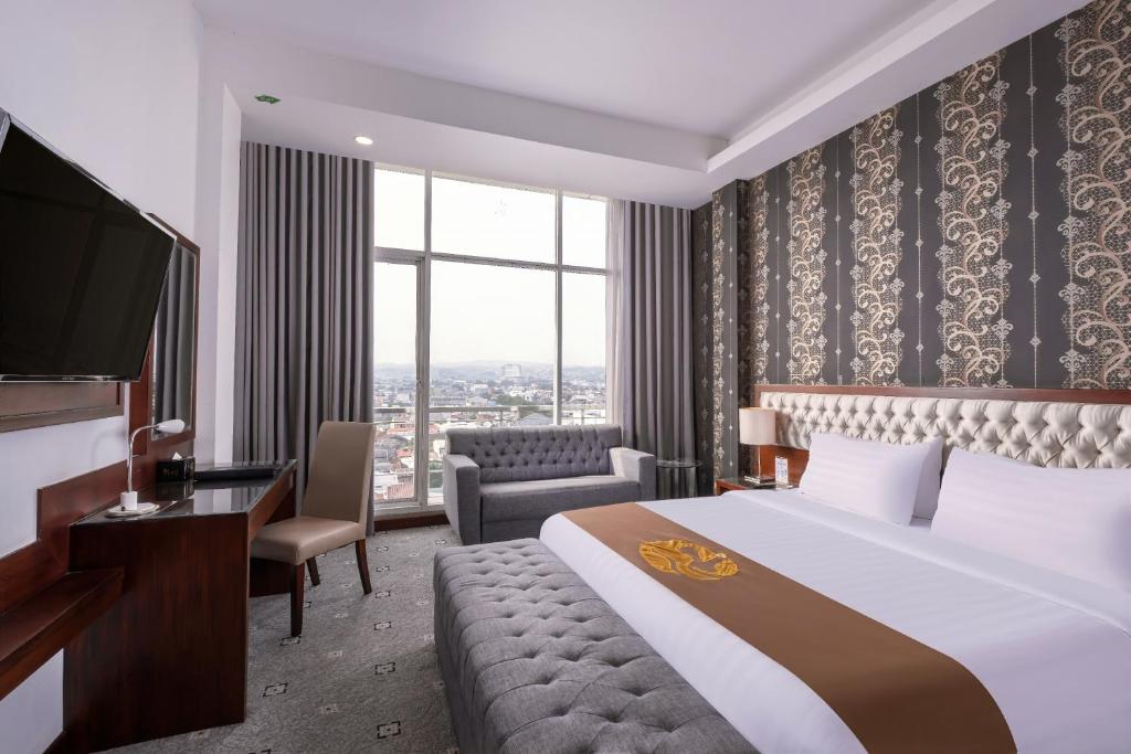 una camera d'albergo con letto e TV di Gets Hotel Semarang a Semarang