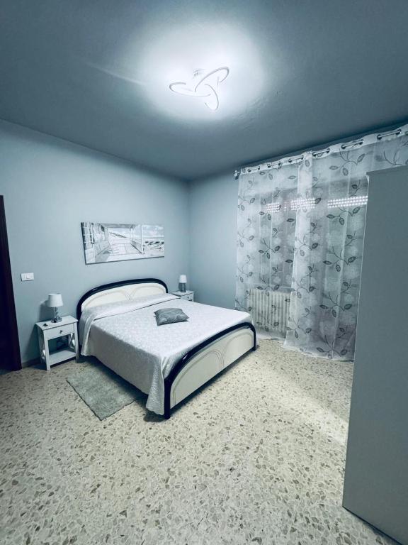 a bedroom with a bed in a blue room at CASA VACANZE DA LUCA in SantʼElpidio a Mare