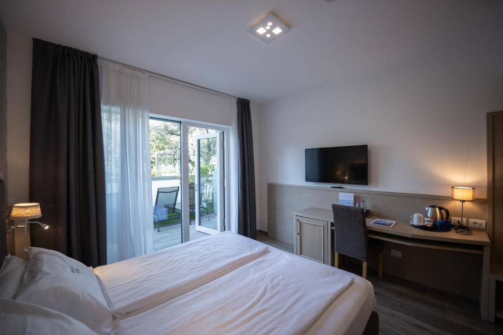 Postel nebo postele na pokoji v ubytování Hotel Bellariva