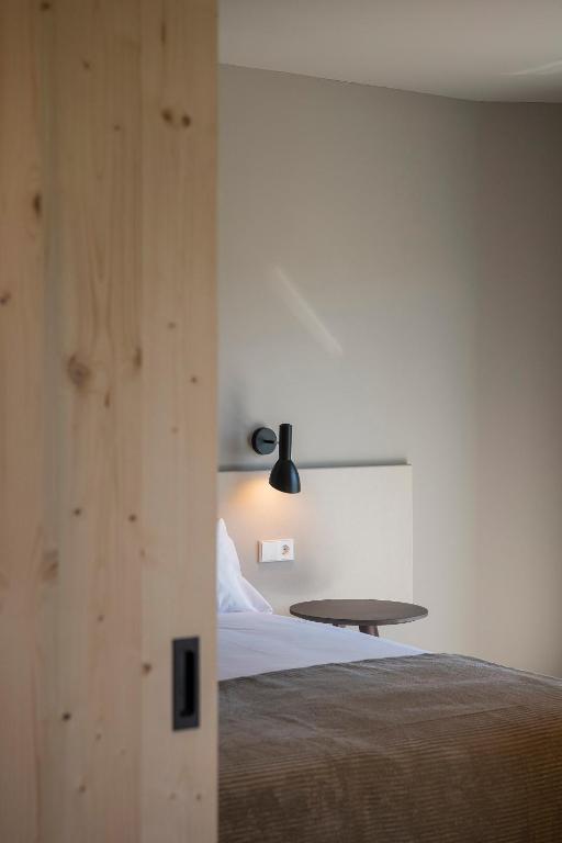 Postel nebo postele na pokoji v ubytování APARTAMENTS LA CARPA