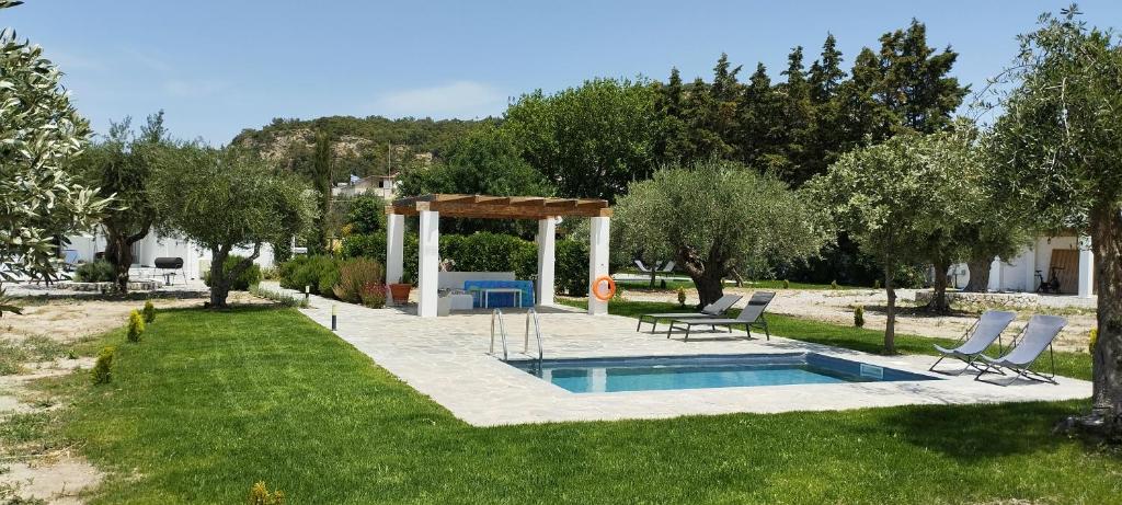 a pool in a yard with a gazebo at Elia suites in Ialysos