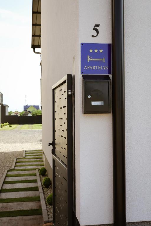 a pay meter on the side of a building at Apartman BUCO in Đakovo