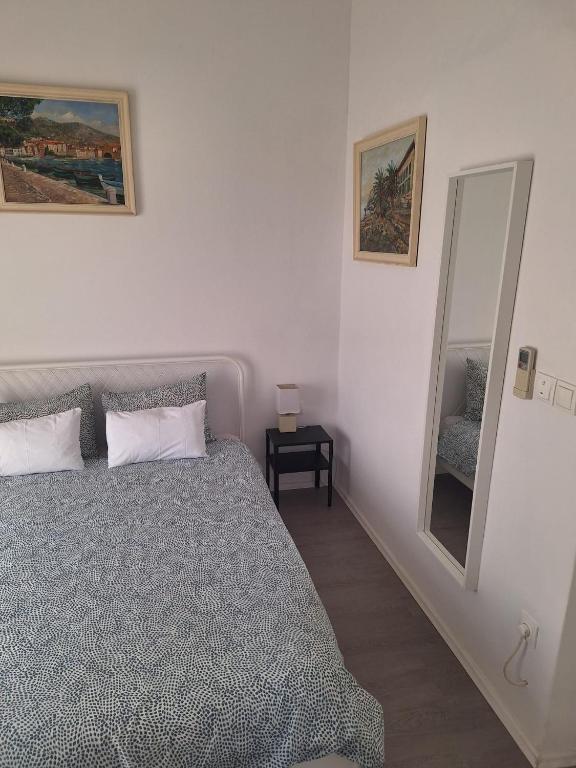 a bedroom with a bed and a mirror at Pension Oaza in Hvar