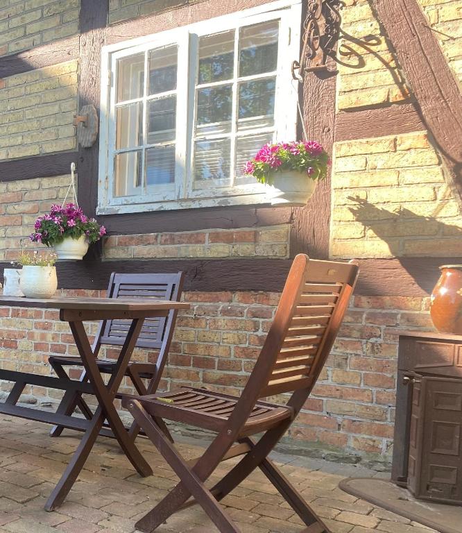 a wooden chair sitting in front of a building at Cottage in Nüchel