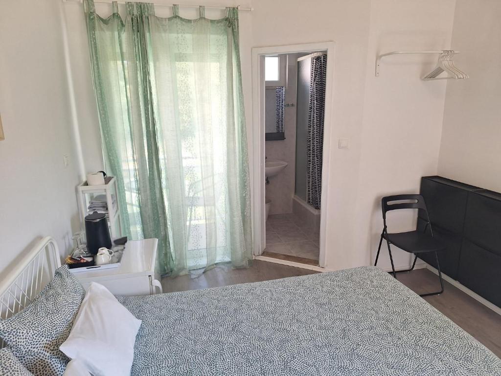 a bedroom with a bed and a door to a bathroom at Pension Oaza in Hvar