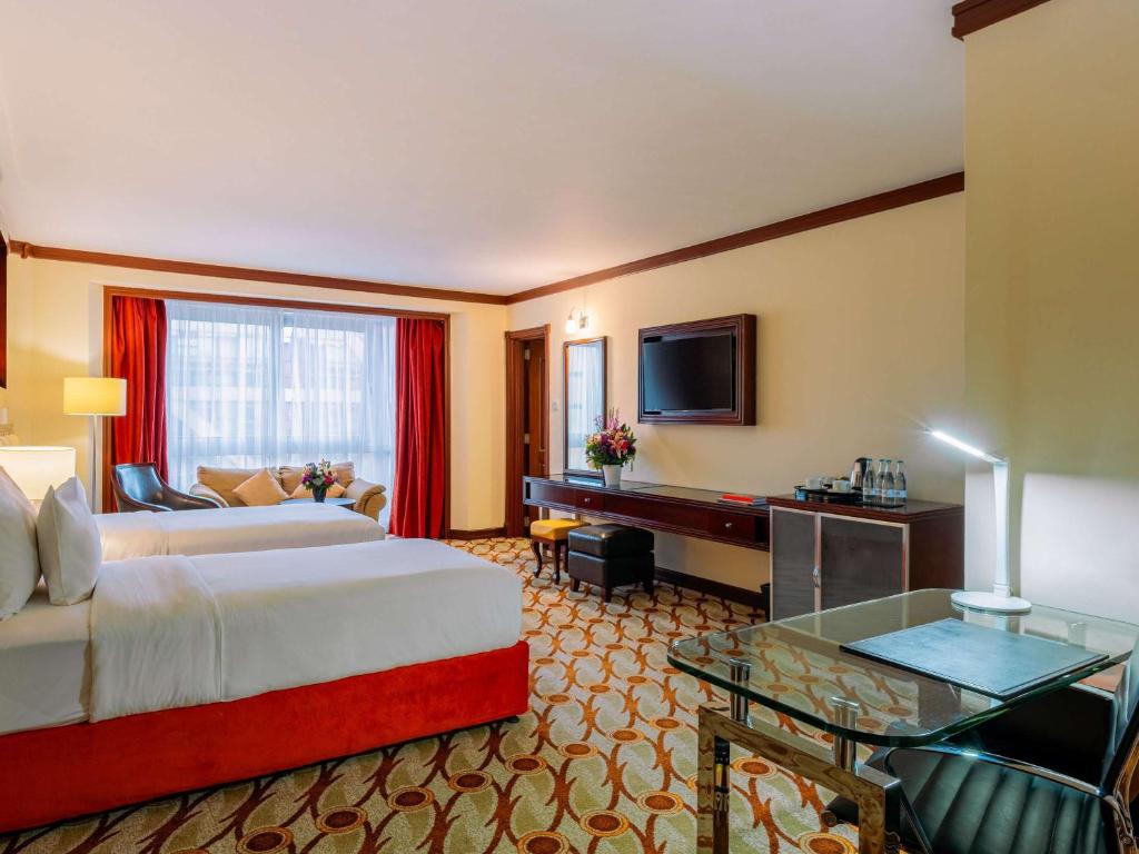 Postel nebo postele na pokoji v ubytování Mövenpick Hotel & Residences Nairobi