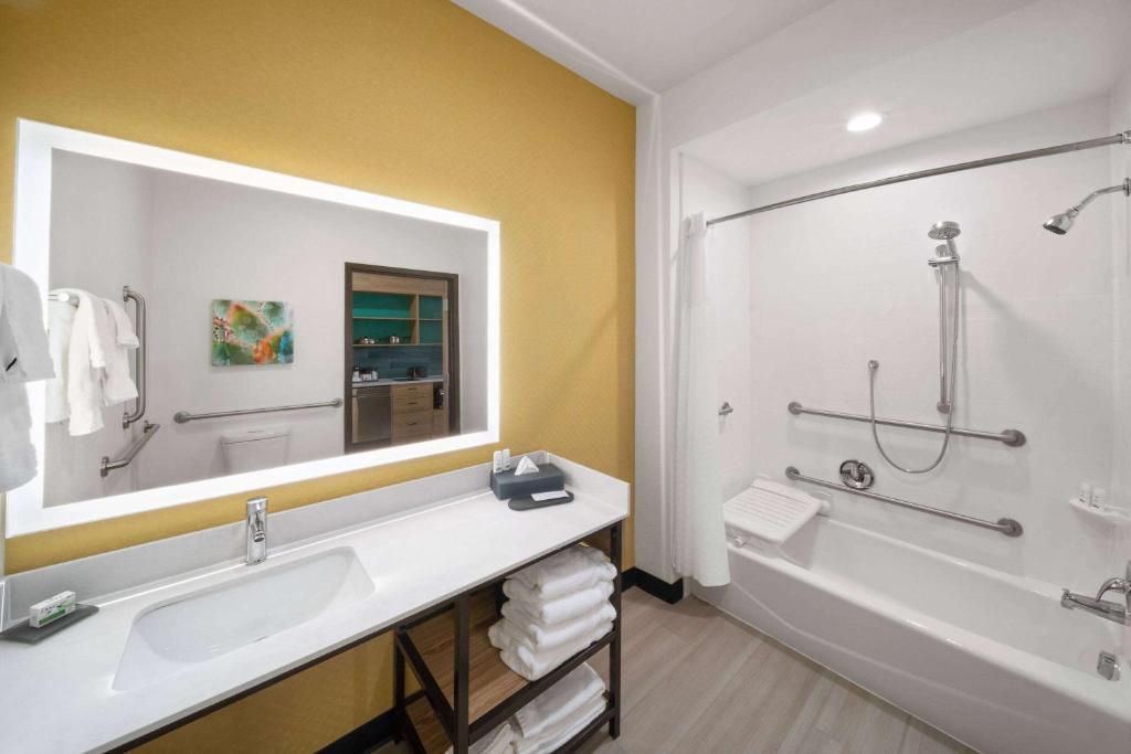 a bathroom with a large mirror and a tub and a sink at La Quinta Inn & Suites by Wyndham El Paso East Loop-375 in El Paso