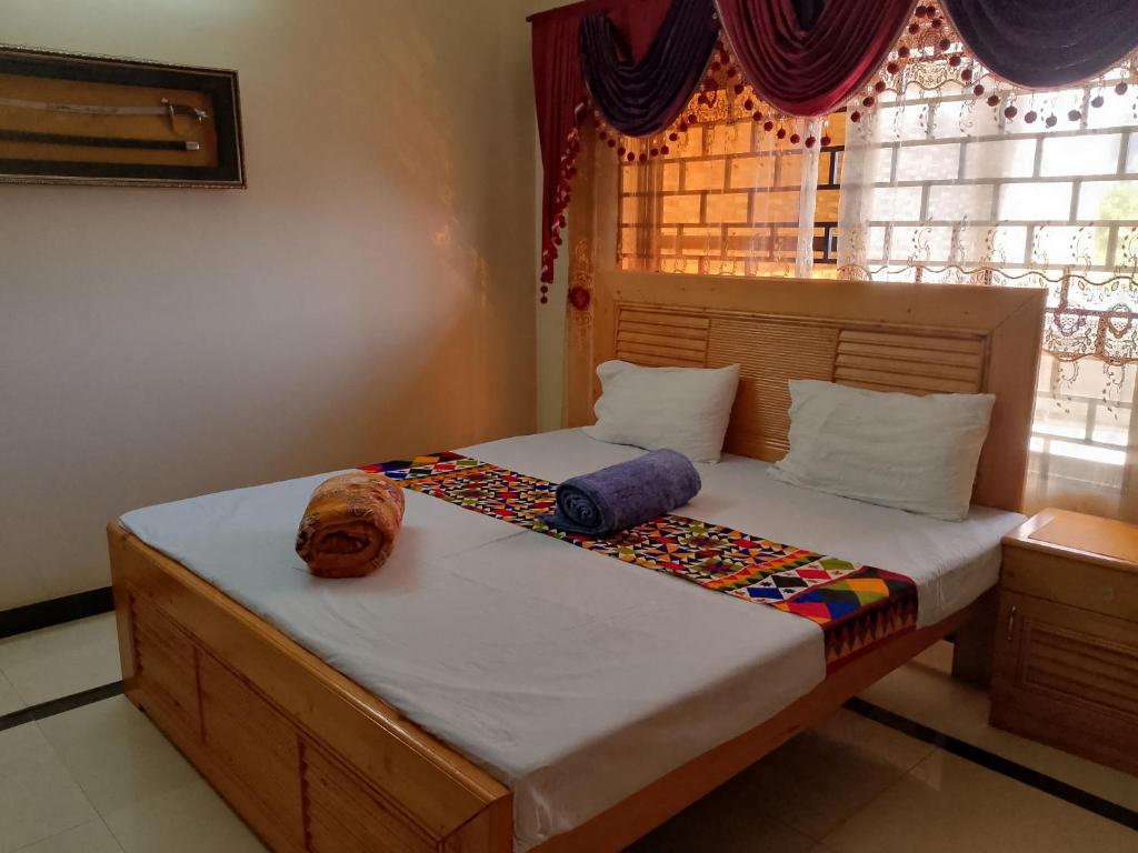 穆札法拉巴德的住宿－Mount Heaven Lodges Muzaffarabad，一间卧室配有带两个枕头的床和窗户