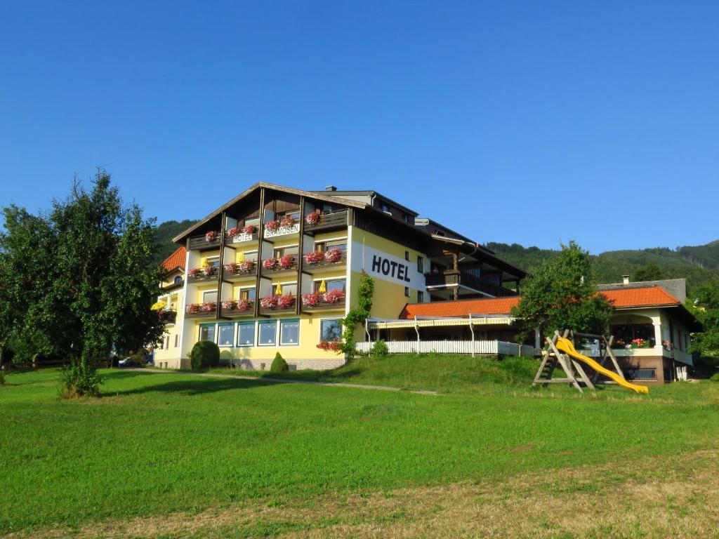 a hotel building with a playground in front of it at Gasthof-Hotel Bramosen in Weyregg