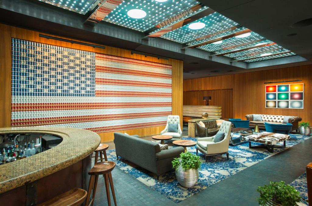 a lobby with an american flag on the wall at Dream Downtown, by Hyatt in New York