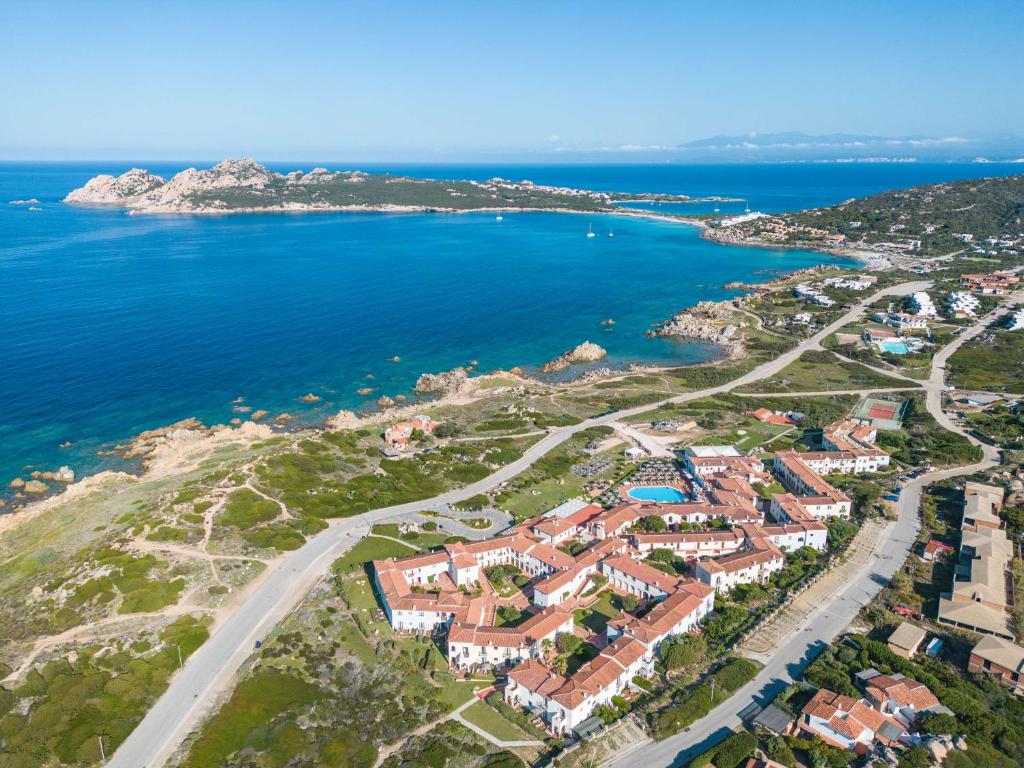 an aerial view of a villa on the coast of the ocean at Mangia's Santa Teresa Sardinia, Curio Collection by Hilton in Santa Teresa Gallura