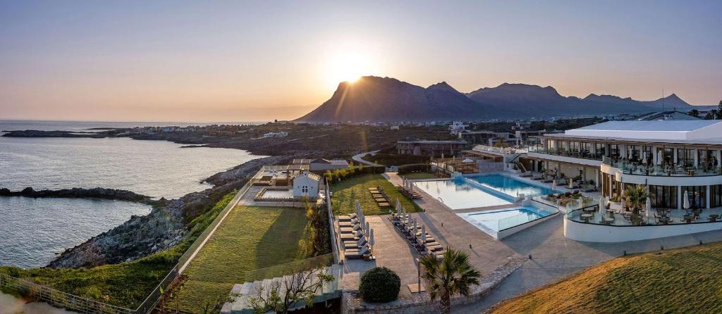 an aerial view of a resort with a mountain at Isla Brown Chania Resort, Curio Collection by Hilton in Stavros
