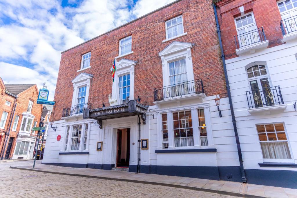 a large brick building on a city street at The White Hart Hotel Lincoln in Lincoln
