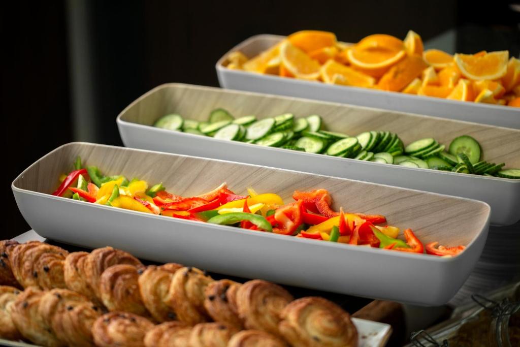 three trays of different types of vegetables and pretzels at Wakeup - Aarhus in Aarhus