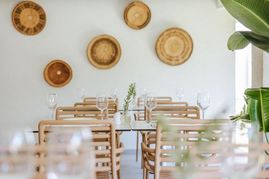 a dining room with a table with chairs and wine glasses at Nissi Park Hotel in Ayia Napa