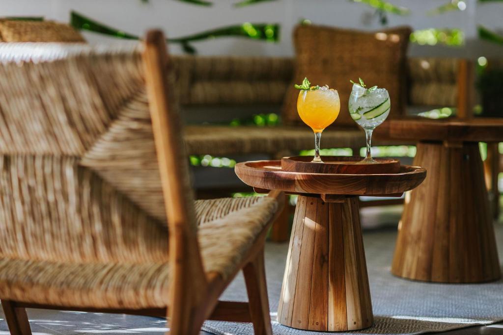 two glasses of orange juice sitting on wooden tables at Nissi Park Hotel in Ayia Napa