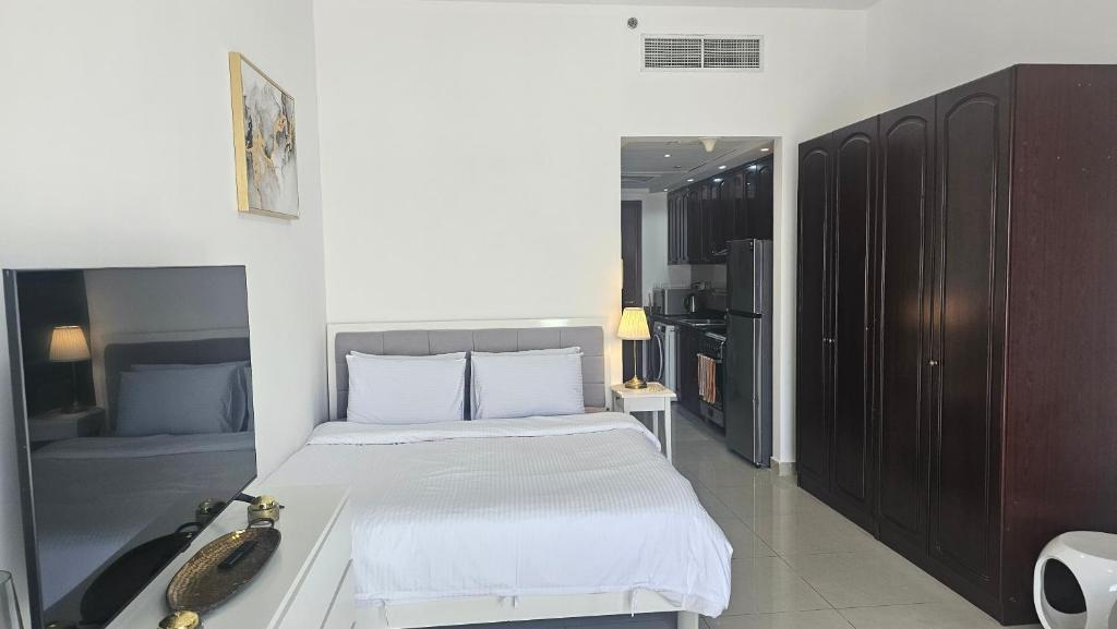 a bedroom with a bed with a phone on it at Chloe studio near the beach in Ras al Khaimah