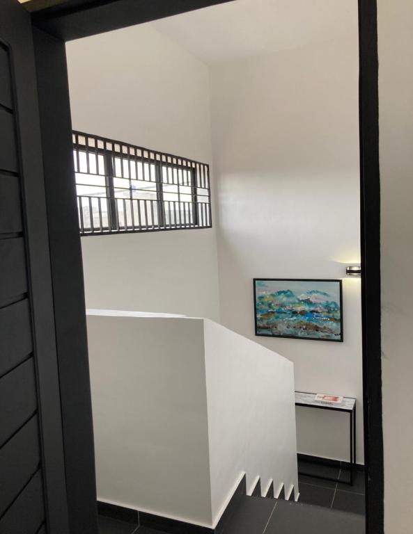 a room with a white wall and a window at LUXURYs apartment in Abomey-Calavi
