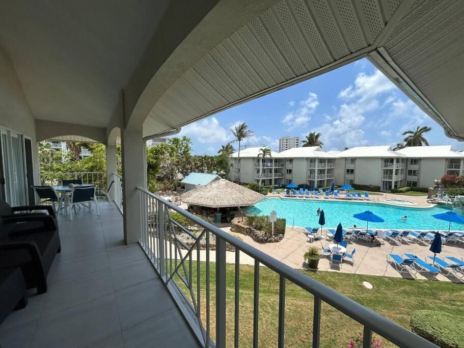 a view of the pool from the balcony of a resort at Sunset Cove - Condo 314 in George Town