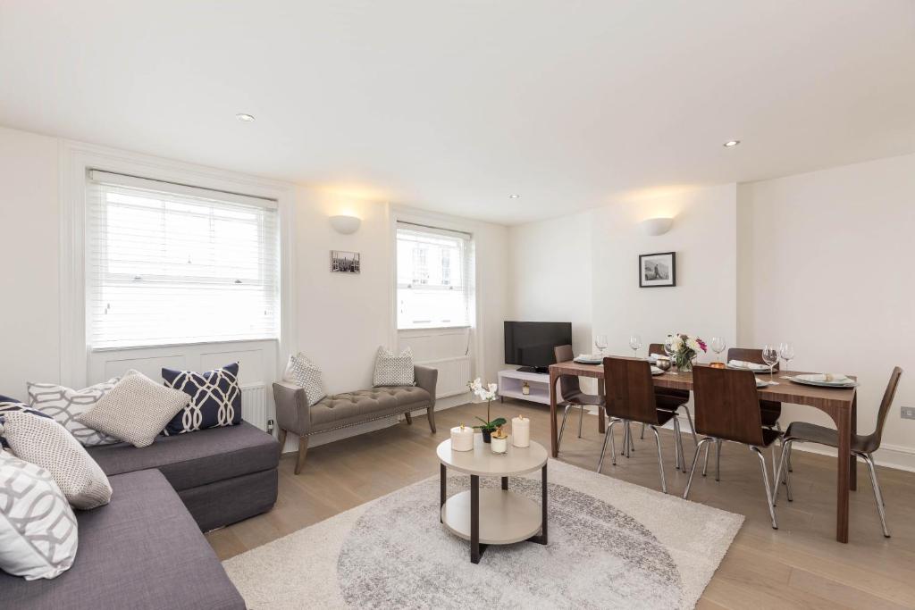 a living room with a couch and a table at Covent Garden 2BR - Urban Chic Apartment in London