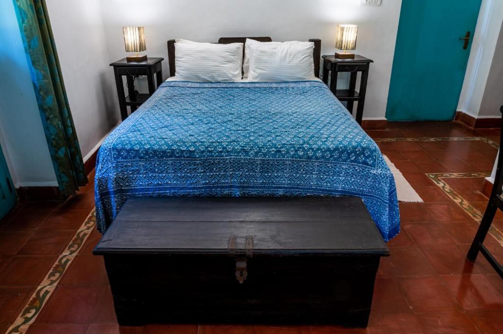 Postel nebo postele na pokoji v ubytování Island House Goa