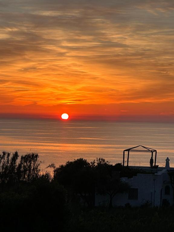 a sunset over the ocean with the sun in the sky at Hotel Boutique Ideal in Ischia