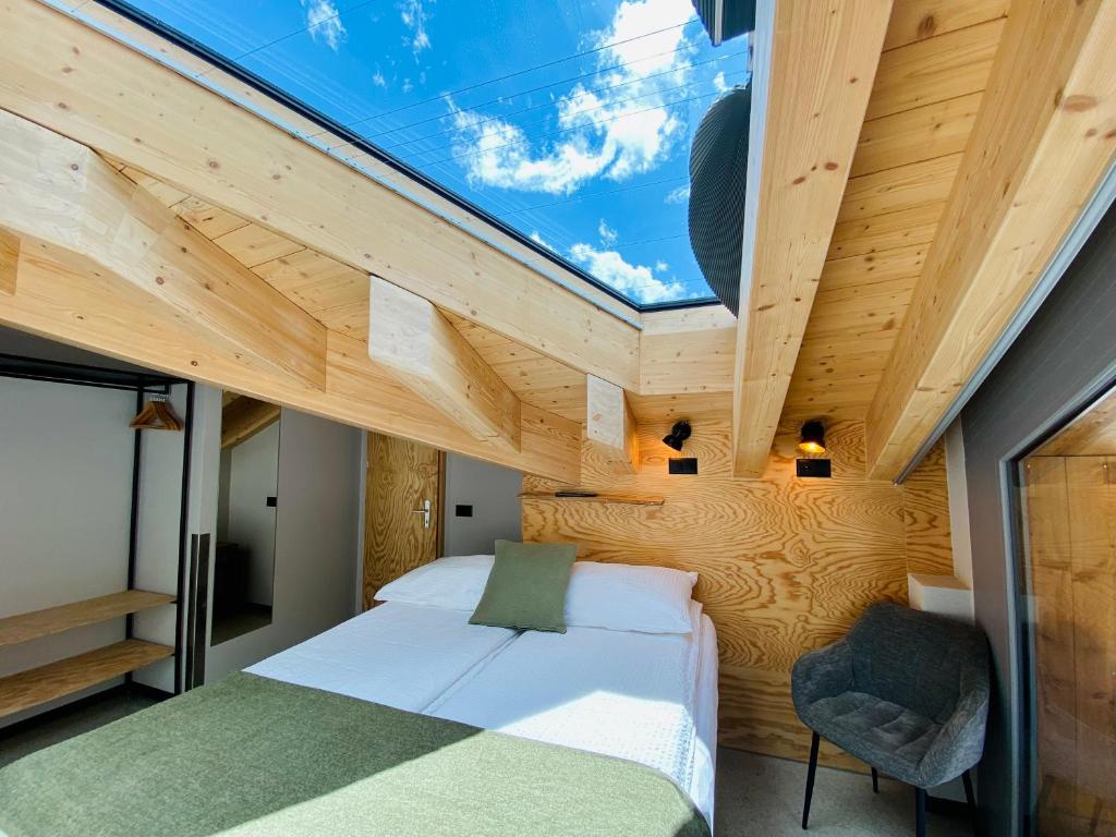 a bedroom with a large skylight in the ceiling at Peaky Riders Self Check-in Hotel in Zermatt