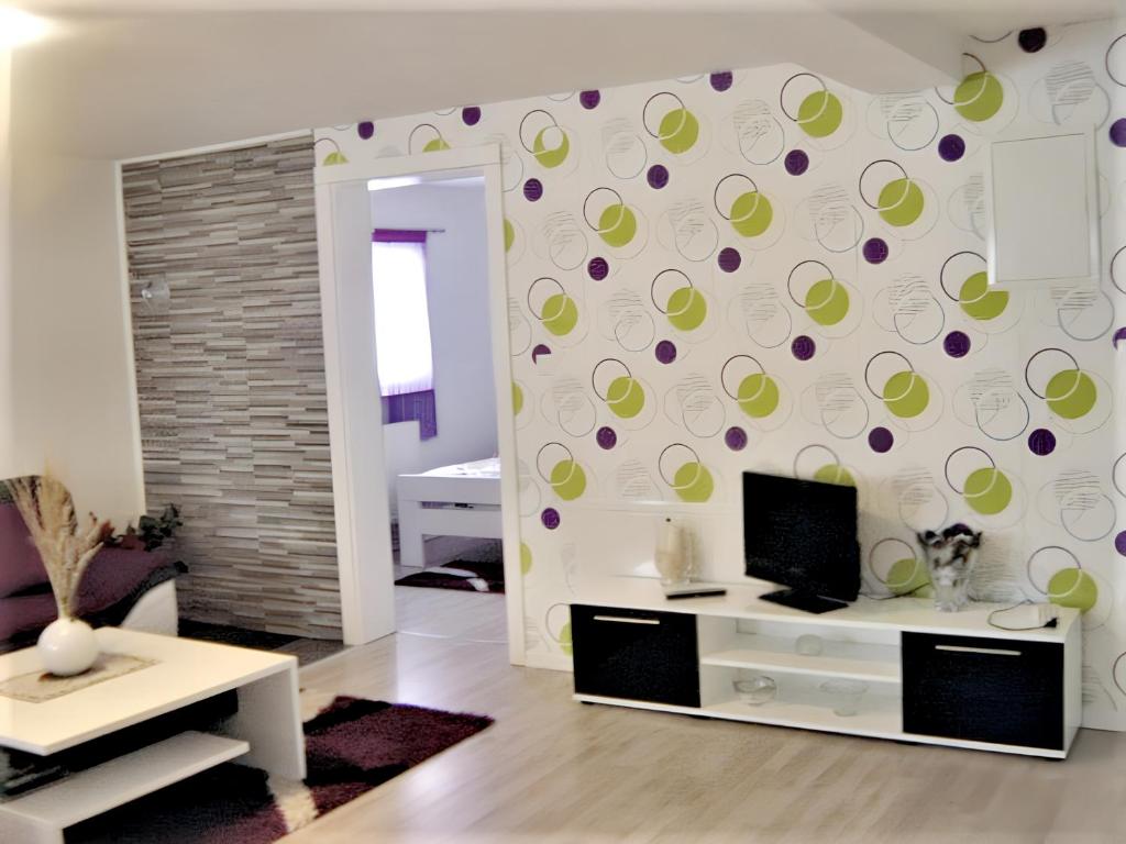 a living room with a wall with green and purple circles at 3 bedrooms apartement with furnished garden and wifi at Rakovica in Rakovica