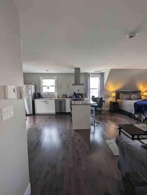 a living room with a couch and a kitchen and a living room at Dominion Place Studio in Moncton