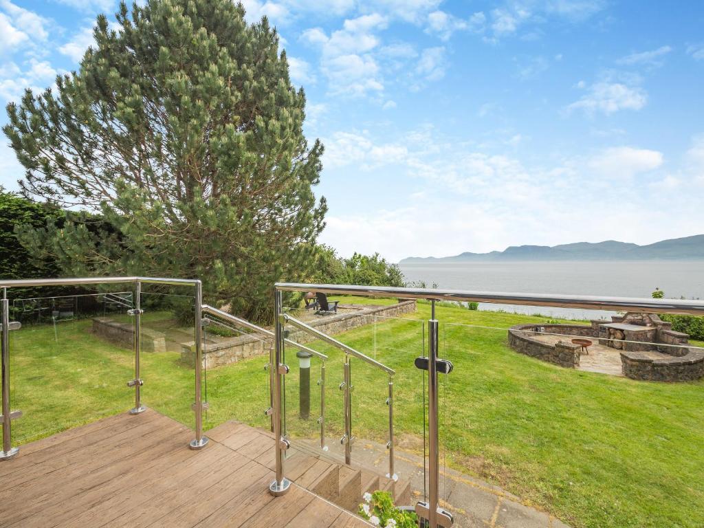 a deck with a view of the water at Ty Glan Mor the Beach House in Llangoed