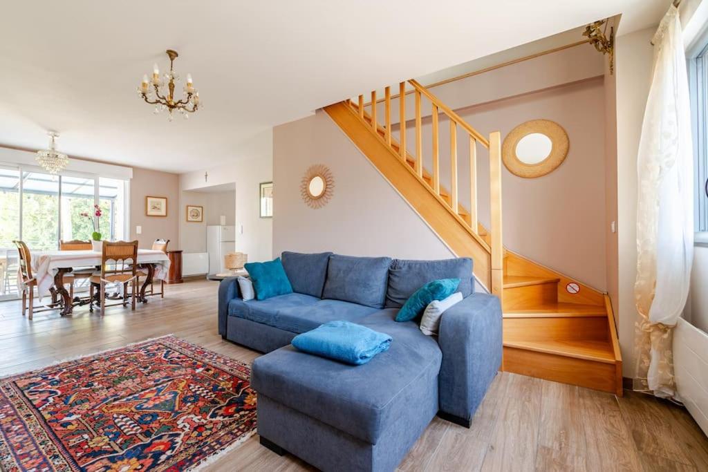 - un salon avec un canapé bleu et un escalier dans l'établissement Le Coin Fertois, à La Ferté-sous-Jouarre
