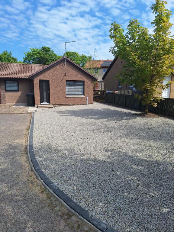 una casa in mattoni con un vialetto di fronte di 5 Fulmar Road**Next to West Beach and Golf Course a Lossiemouth
