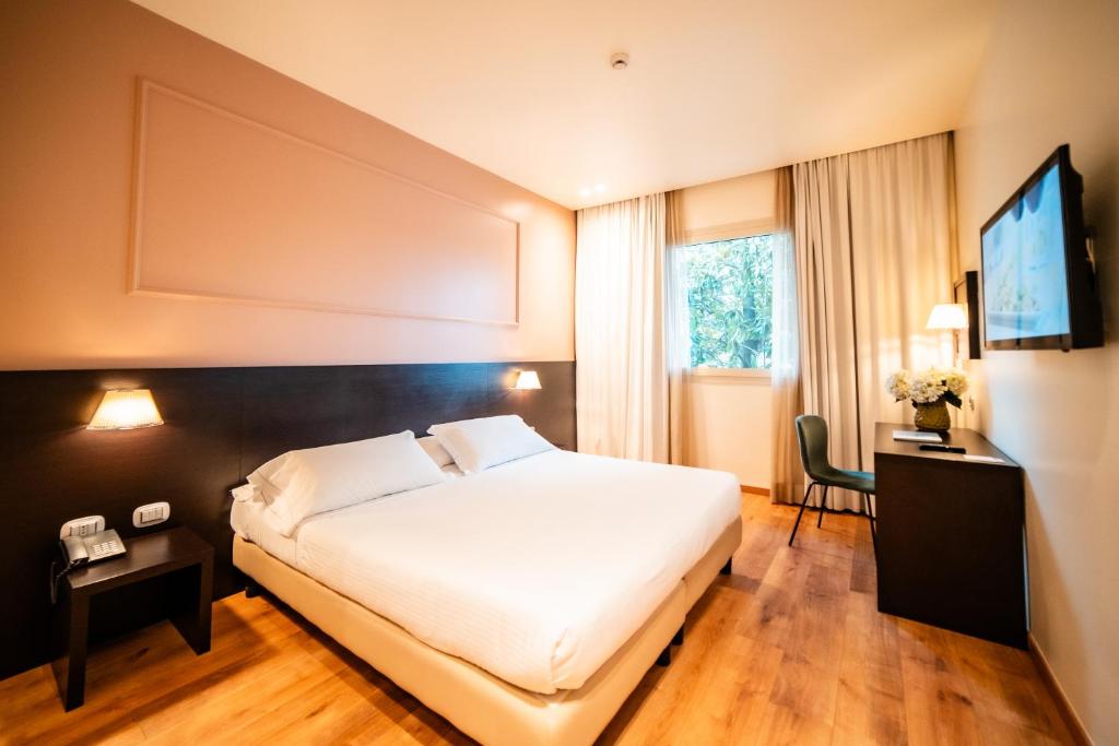 Postel nebo postele na pokoji v ubytování Hotel Capolago