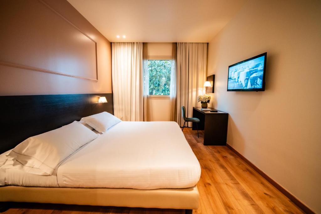 Postel nebo postele na pokoji v ubytování Hotel Capolago