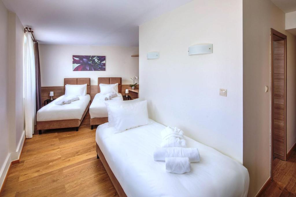 Postel nebo postele na pokoji v ubytování Vitta Hotel Superior