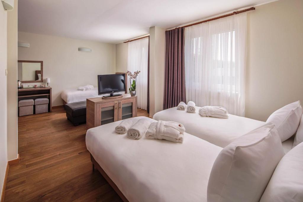 Postel nebo postele na pokoji v ubytování Vitta Hotel Superior