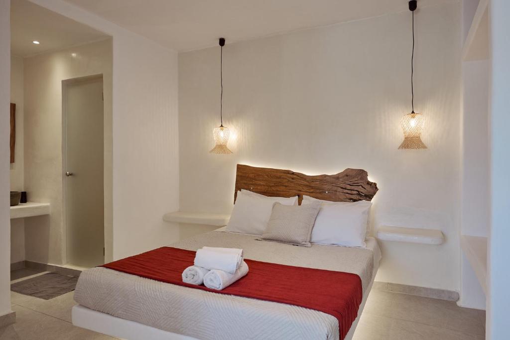 a bedroom with a bed with two towels on it at Casa Philippi Suites in Mýkonos City