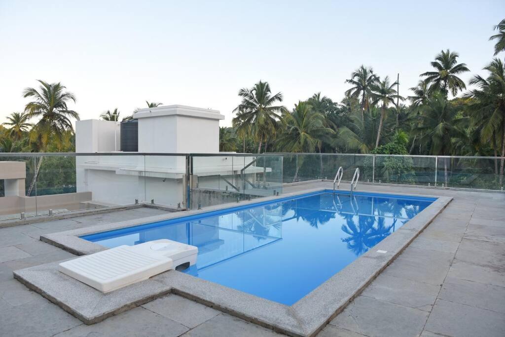 a swimming pool on top of a building at Ranghavi sands Apartment with Pool - near beach and Dabolim Airport in Bogmolo
