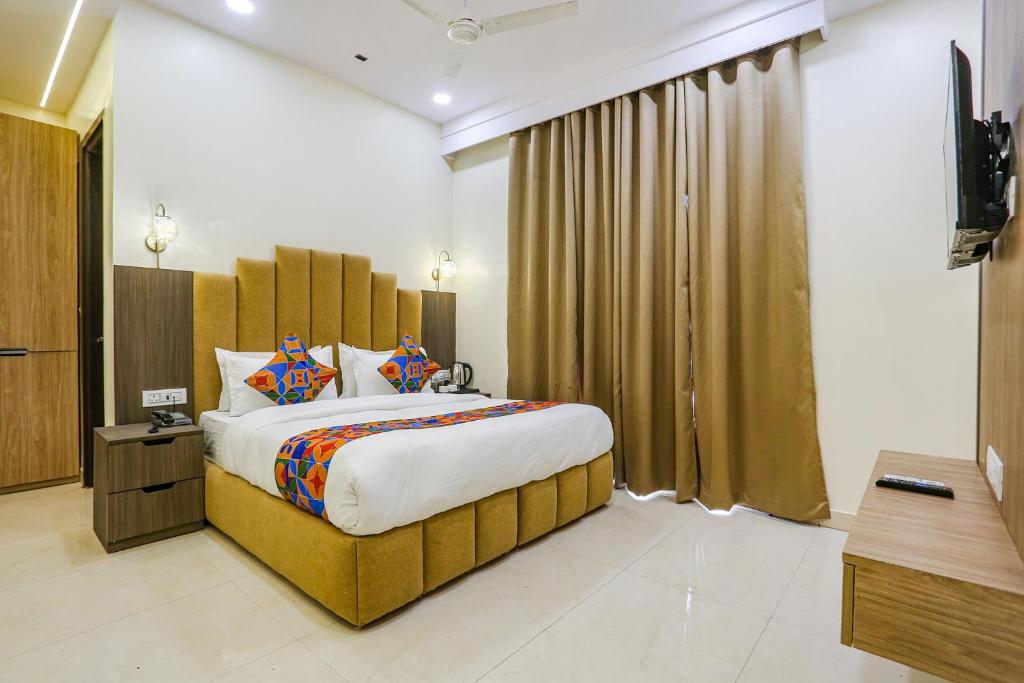 a bedroom with a large bed in a room at FabHotel Vishesh Villas in New Delhi