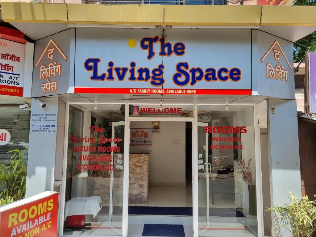 a building with a sign that reads the living space at The Living Space in Lonavala