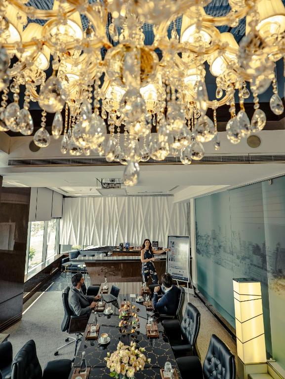 a group of people sitting around a long table in a room at Golden Sands Boutique Hotel-Dubai Creek in Dubai