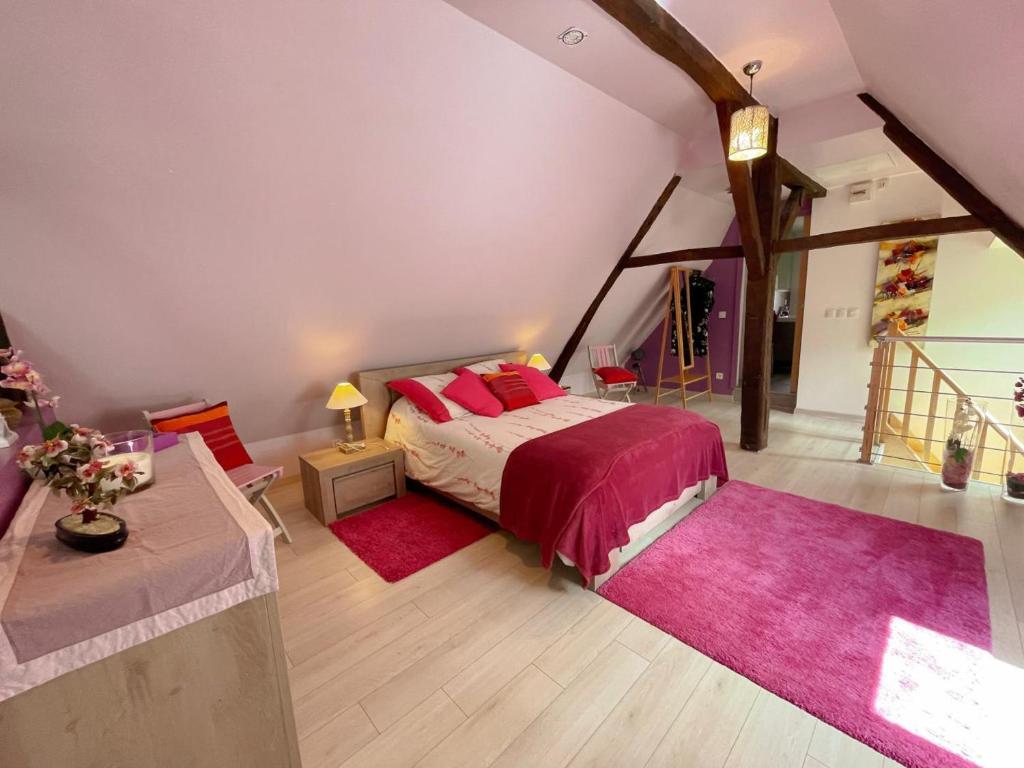 une chambre avec un lit avec des oreillers rouges dans l'établissement Gîte rénové 2024 calme et proche du centre, tout inclus, équipé et confortable, idéal pour découvrir Amboise - FR-1-381-580, à Amboise