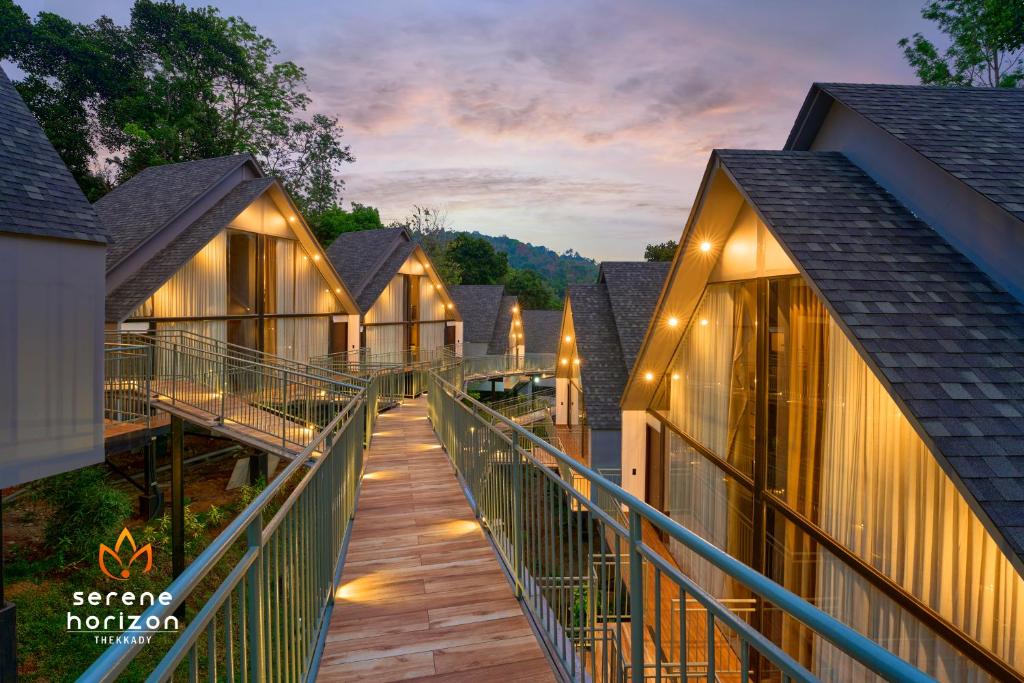 a row of cottages at a resort at dusk at Serene Horizon in Thekkady