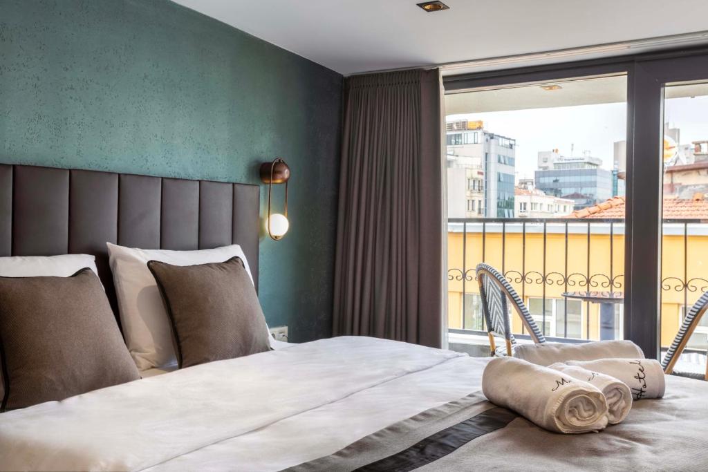 Postel nebo postele na pokoji v ubytování Marlon Hotel
