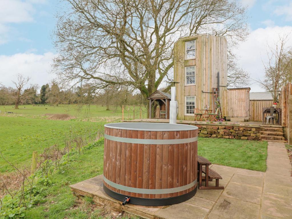 a wooden barrel sitting in front of a house at The Lazy Squire by The Water in Rugeley