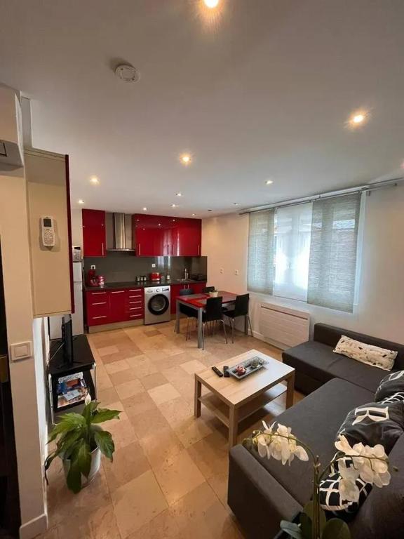 un salon avec un canapé et une table dans l'établissement Appartement moderne à Aubervilliers - 45 m² - Parking payant, à Aubervilliers