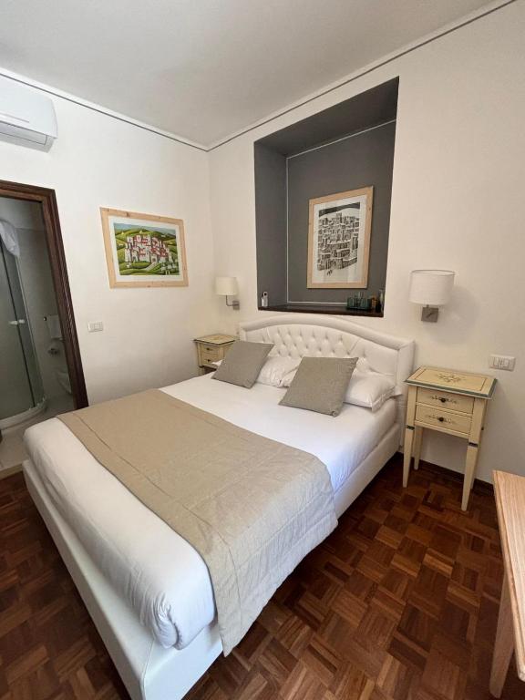 Postel nebo postele na pokoji v ubytování Hotel La Fortezza
