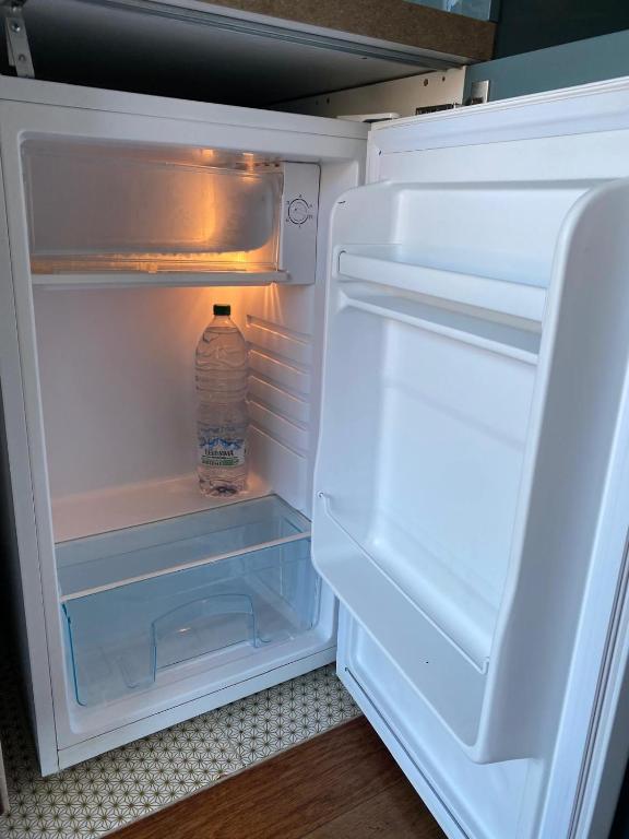 an open refrigerator with a bottle of water in it at B&B il Duca d'Amalfi in Salerno