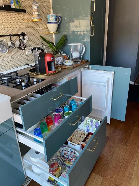 a kitchen with an open refrigerator with food inside at B&B il Duca d'Amalfi in Salerno