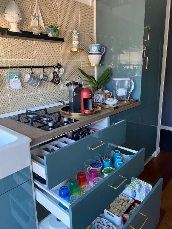 an open drawer in a kitchen with a stove at B&B il Duca d'Amalfi in Salerno
